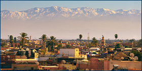 Morocco Corporate Payment Survey 2021: shortened delays but still widespread late payments. Image of Marrakesh city skyline in Morocco with snowy Atlas mountains in the background.
